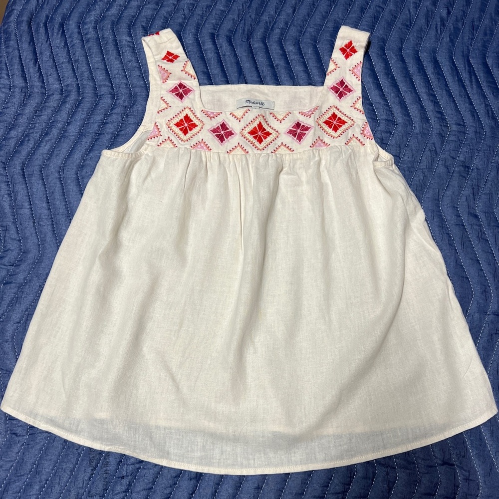 Girl’s small top. White with red embroidered accents. No flaws.
